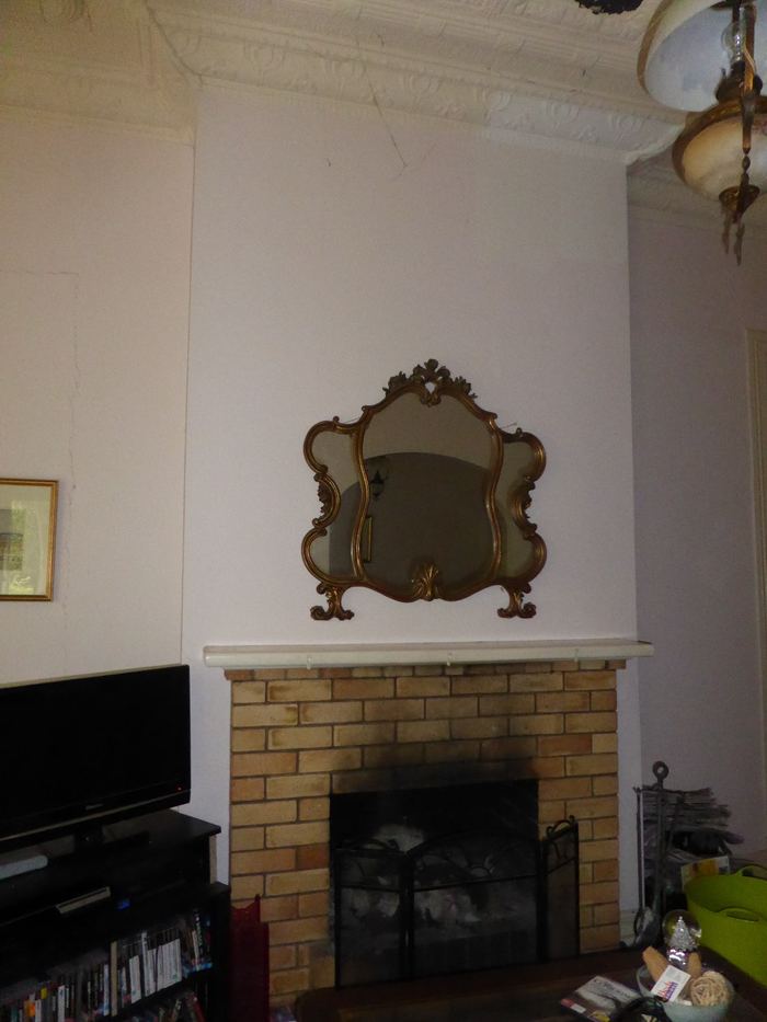 Clayfield Queenslander fireplace wall before painting, with a brick surround