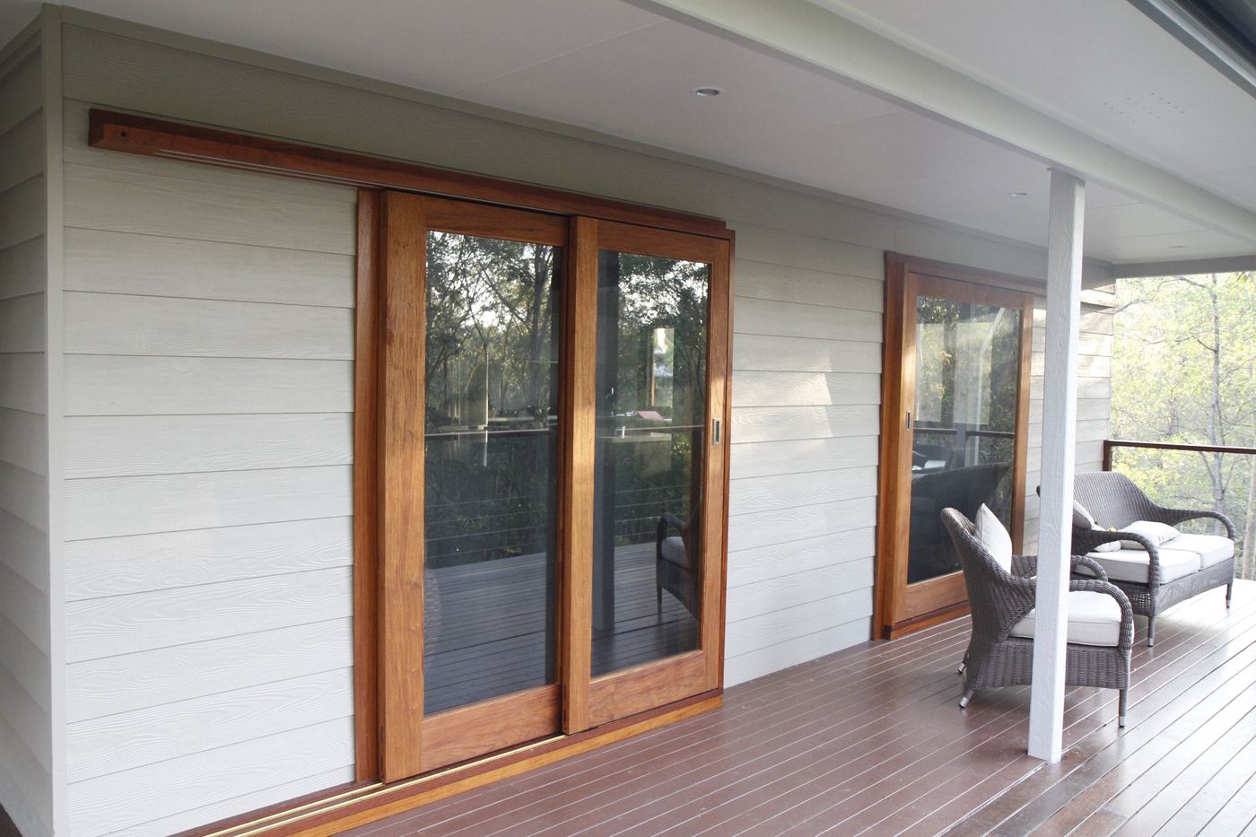 After: the Clear Mountain verandah wall painted white, with timber-framed sliding doors