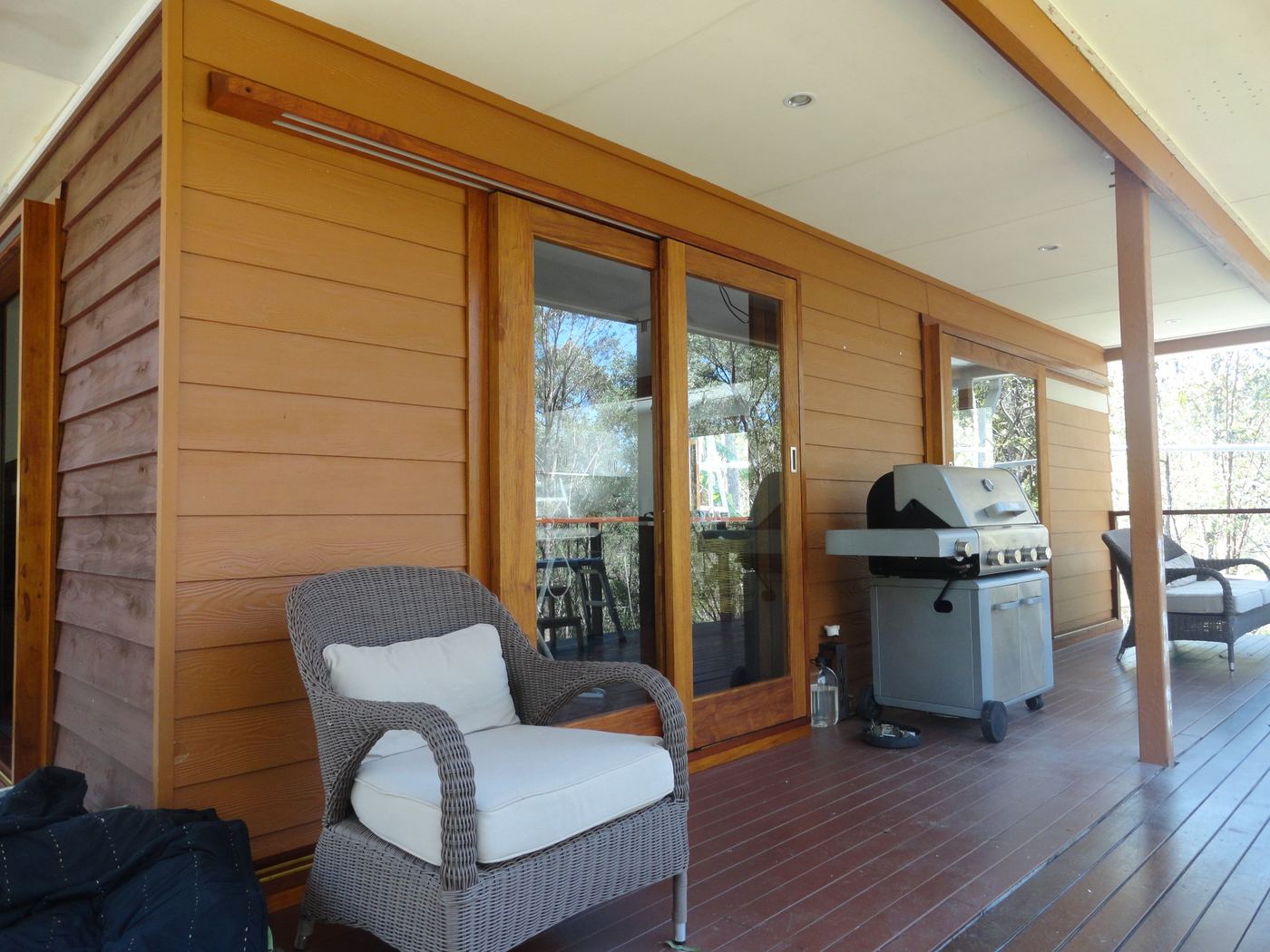 Before: the same verandah with orange stained timber cladding