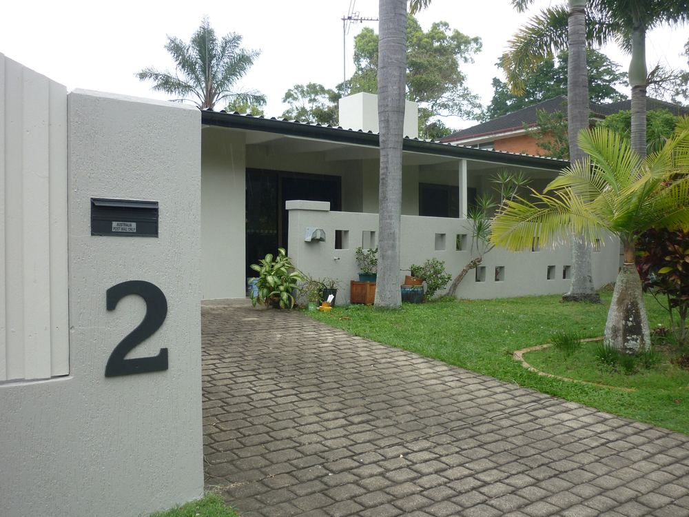 Indooroopilly house exterior and letterbox wall with a large number 2